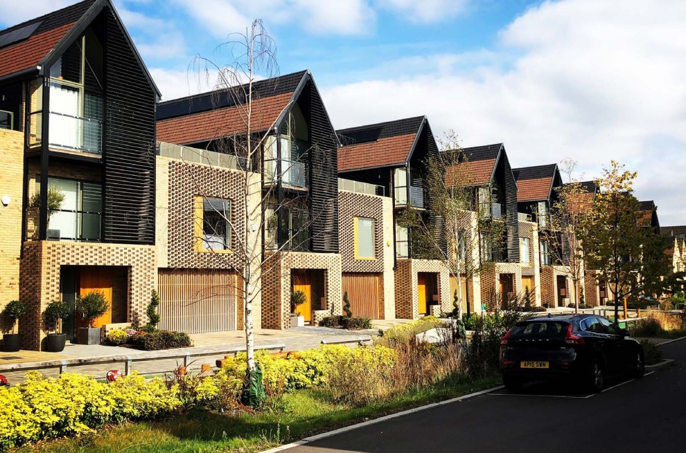 Row of modern houses with lots of plants and greenery.