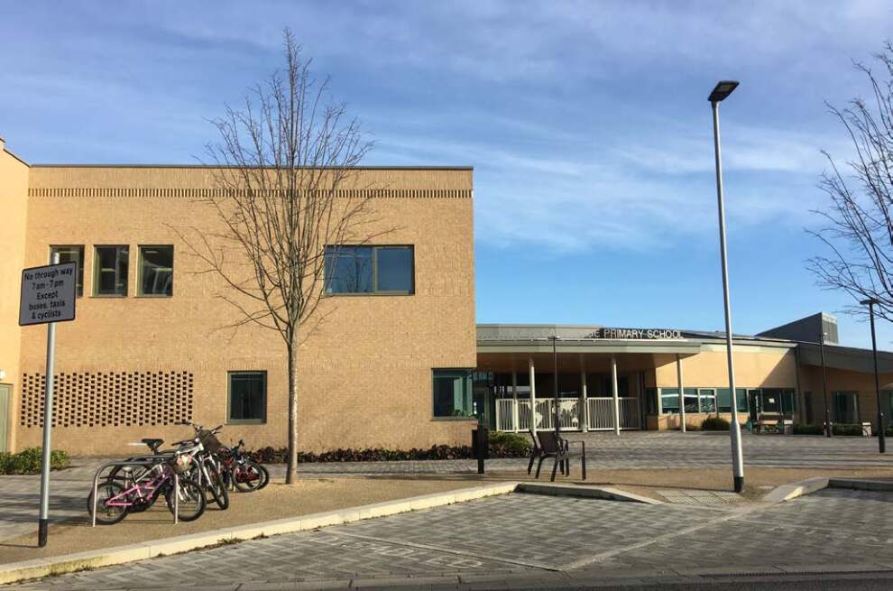 Public building with a path leading up to it, and bike racks with bikes outside.