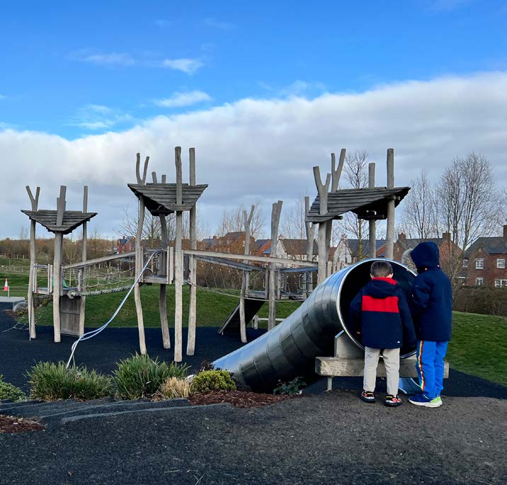 Children's park with metal slides and wooden apparatus