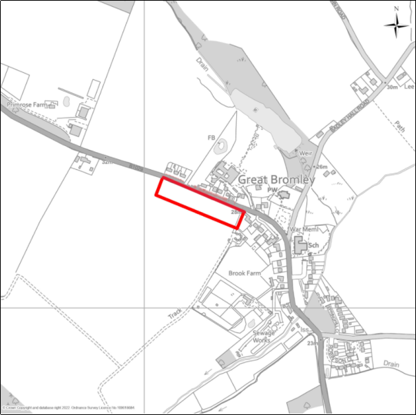 A grayscale map showing the boundary of the Land south of Hall Road, Great Bromley with a red outline. 