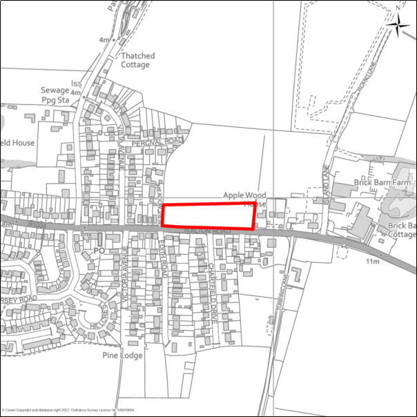 A grayscale map showing the boundary of the Land north of Walton Road, Kirby-le-Soken with a red outline. 