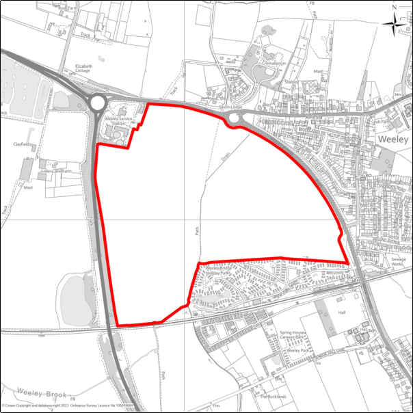 A grayscale map showing the boundary of Weeley Green Garden Village with a red outline. 